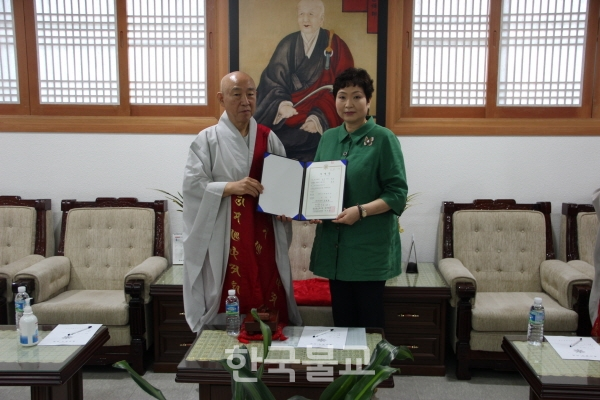 인천교구 주재기자로 임명된 승만 이용애 씨가 총무원장 호명 스님과 기념촬영을 하고 있다.