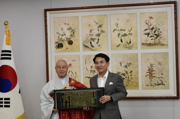 총무원장 상진 스님이 김진태 강원지사에게 목판본 반야심경을 선물하고 있다.